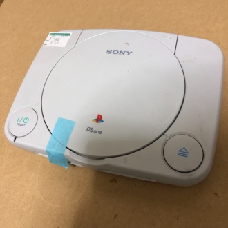 PSoneのディスクカバーが開かないようにマスキングテープで固定中